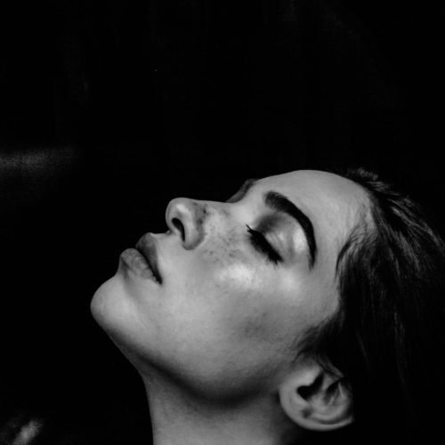 grayscale photo of a woman wearing white off-shoulder shirt